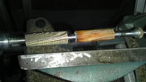 Two kinds of wood being turned on lathe.